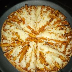 A picture of French fries pizza.