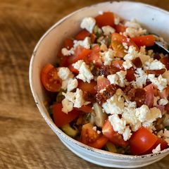 A picture of Summer salad - spelt, coriander, tomato, artichoke, dried tomato, red onion, cucumber, paprika, feta.