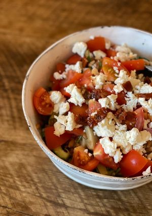 A picture of Summer salad - spelt, coriander, tomato, artichoke, dried tomato, red onion, cucumber, paprika, feta.