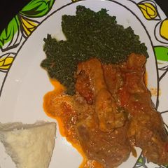 A picture of Ugali,chicken stew with greens.