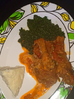 A picture of Ugali,chicken stew with greens.