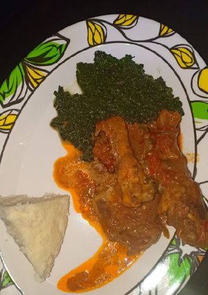 A picture of Ugali,chicken stew with greens.