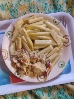A picture of Fried yam with fried eggs.