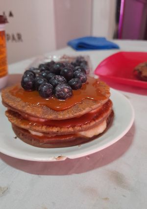 Una foto de Pancakes de chocolate con dulce de leche, banana y arándanos