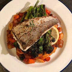 A picture of Seared hake. Butterbean, chorizo and olive stew. Purple sprouting broccoli.