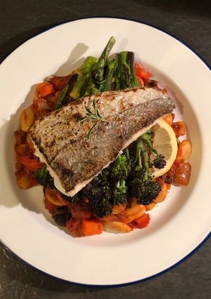 A picture of Seared hake. Butterbean, chorizo and olive stew. Purple sprouting broccoli.