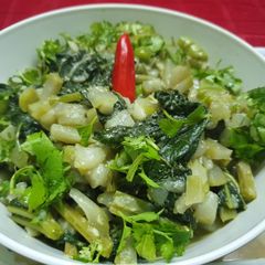 A picture of Lau Shaager Morich Jhol(Bottle Gourd and Leaves in Poppy Paste).