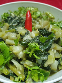 A picture of Lau Shaager Morich Jhol(Bottle Gourd and Leaves in Poppy Paste).