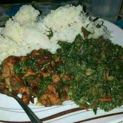 A picture of Rice served with pork and sukuma.