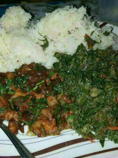 A picture of Rice served with pork and sukuma.