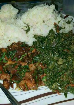 A picture of Rice served with pork and sukuma.