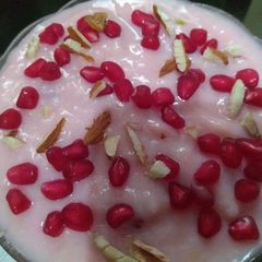 A picture of China Grass Pudding with Chopped nuts and Pomegranate seeds.