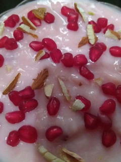 A picture of China Grass Pudding with Chopped nuts and Pomegranate seeds.