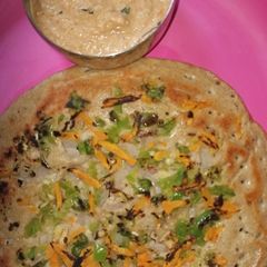 A picture of Utappam with loaded vegetables.