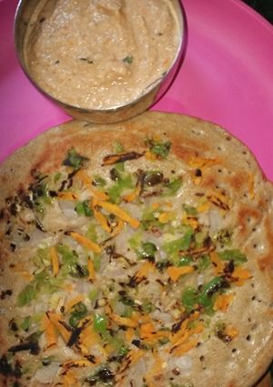 A picture of Utappam with loaded vegetables.