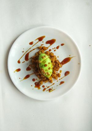 A picture of “Coffee infused Rasgulla crumbs with pistachio ice cream and coffee syrup”.
