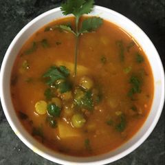 A picture of Allu ki sabji with peas.