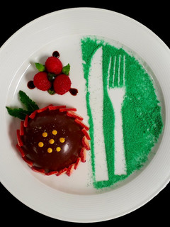 A picture of Choco Glazed Thandai Mousse with Raspberry Compote & Prune Sauce.