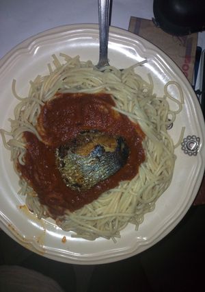 A picture of White spaghetti and stew with fish.