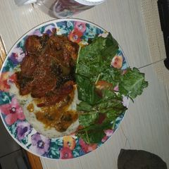 A picture of Smothered pork chops with mash potato.