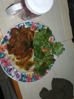 A picture of Smothered pork chops with mash potato.