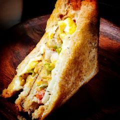 A picture of Cheesy mayo paneer sandwich in tawa.