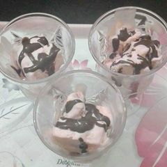 A picture of Tutti fruity ice-cream with chocolate sauce.