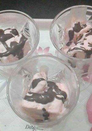 A picture of Tutti fruity ice-cream with chocolate sauce.