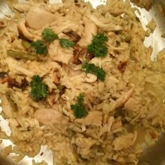 A picture of Rotisserie chicken and yellow rice.