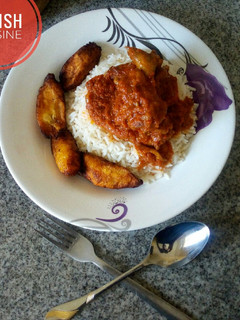 A picture of White rice and chicken stew with plantain!.