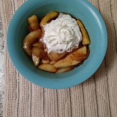A picture of Southern fried apples with homemade whipped cream.
