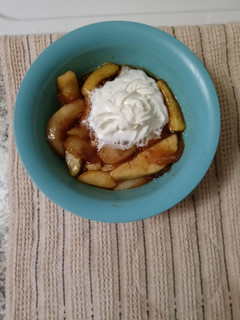 A picture of Southern fried apples with homemade whipped cream.
