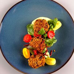 A picture of Beef brisket ragu fritters coated in granola &horseradish hummus.