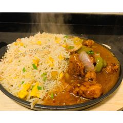 A picture of Sizzling Garlic burnt fried rice with chicken Manchurian.