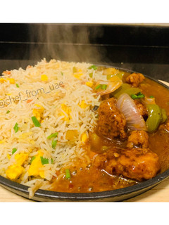 A picture of Sizzling Garlic burnt fried rice with chicken Manchurian.