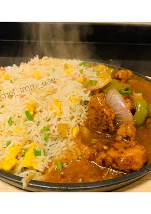 A picture of Sizzling Garlic burnt fried rice with chicken Manchurian.
