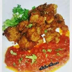 A picture of Tomatoes chutney with fry fish.