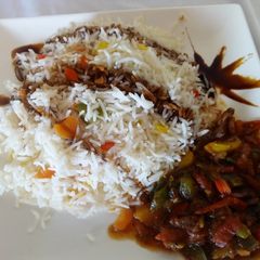 A picture of Vegetable Rice Served With Beef Stew.