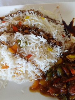 A picture of Vegetable Rice Served With Beef Stew.