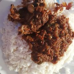 A picture of Rice with peppered stew.