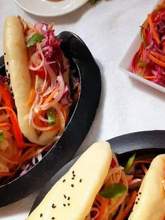 A picture of Chicken Stuffed Chinese Steam bun with pickled vegetables.