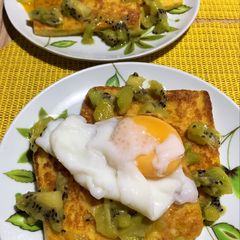 A picture of Breakfast toast with poached egg and kiwi.