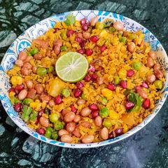 A picture of Red Poha Masala With Veggies, Sprouts and Nuts.