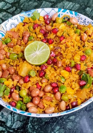 A picture of Red Poha Masala With Veggies, Sprouts and Nuts.