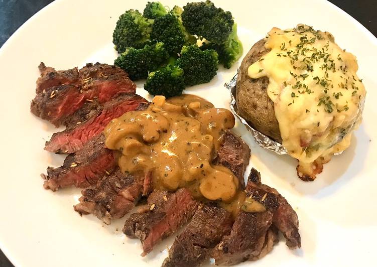 Beef steak with mushroom sauce and baked potato