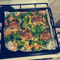 A picture of Oven baked chicken and veggez.