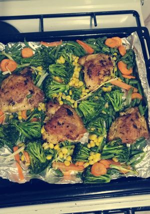 A picture of Oven baked chicken and veggez.