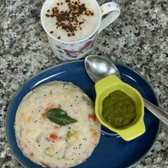 A picture of Veggie upma with mint chutney with coffee ☕️.