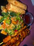 Teriyaki chicken and pineapple skewers with fried rice and veggies and eggs rolls