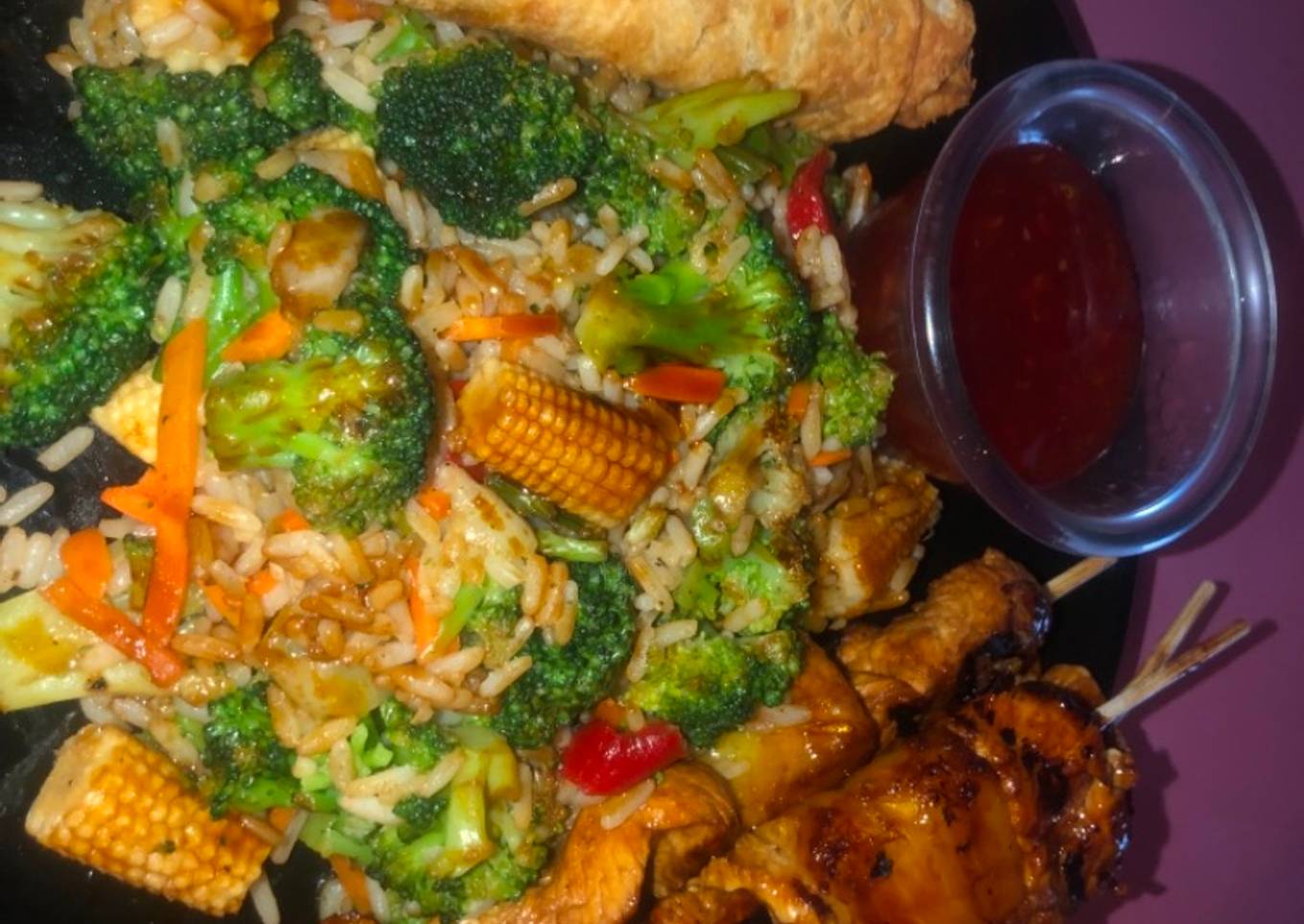 Teriyaki chicken and pineapple skewers with fried rice and veggies and eggs rolls